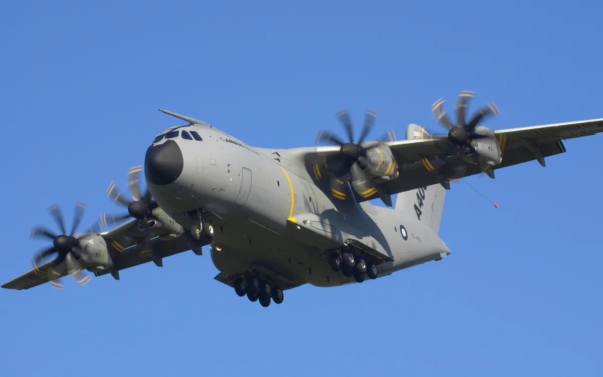 Representative Airbus A400M Atlas on approach, seen from below.