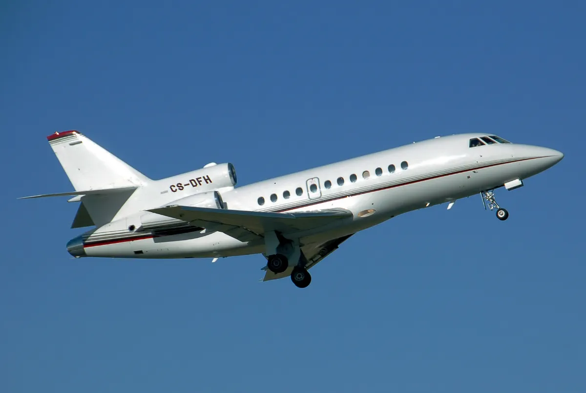 Representative Dassault Falcon 900 climbing after takeoff.
