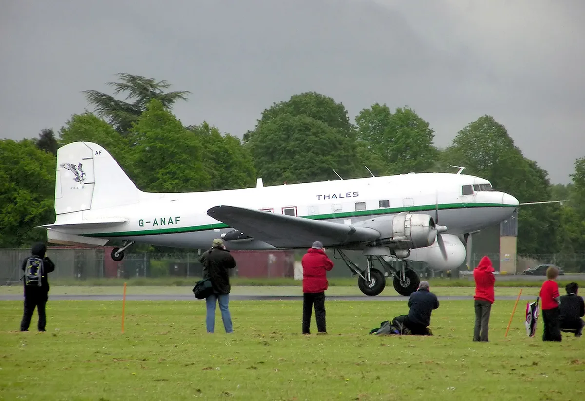 Representative Douglas DC-3 modified as a radar test aircraft, taking off in a side view.