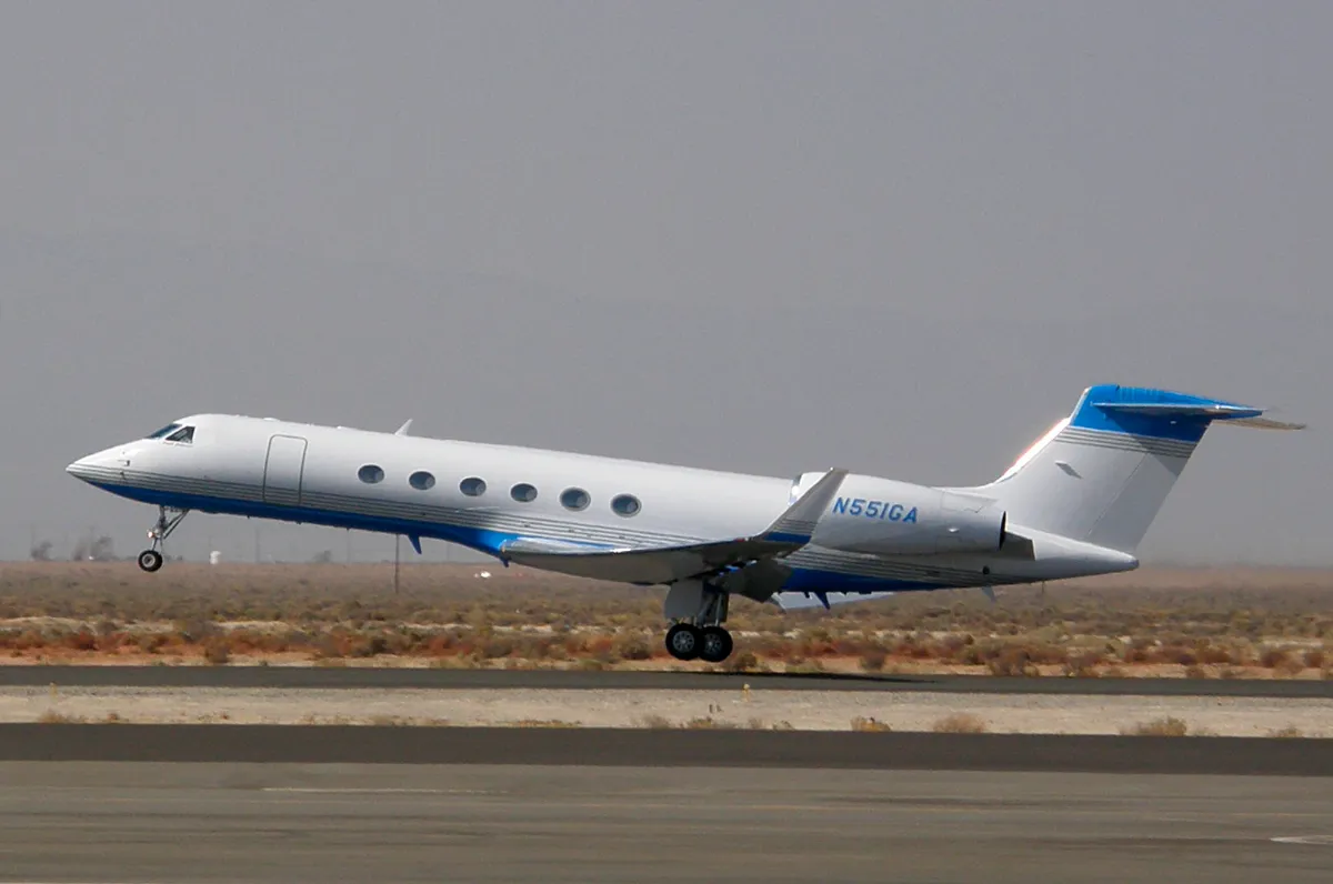 Representative Gulfstream V taking off from a desert airfield.