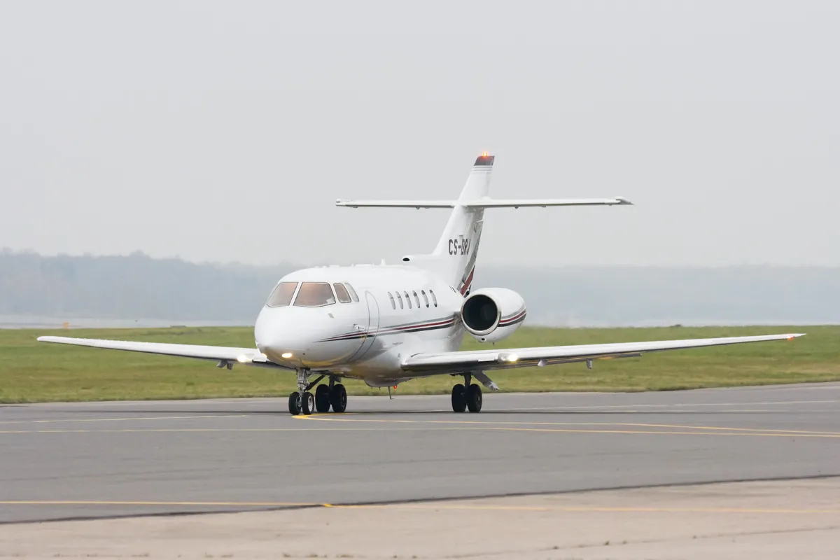 Representative Hawker 800XP taxiing on an airport apron.