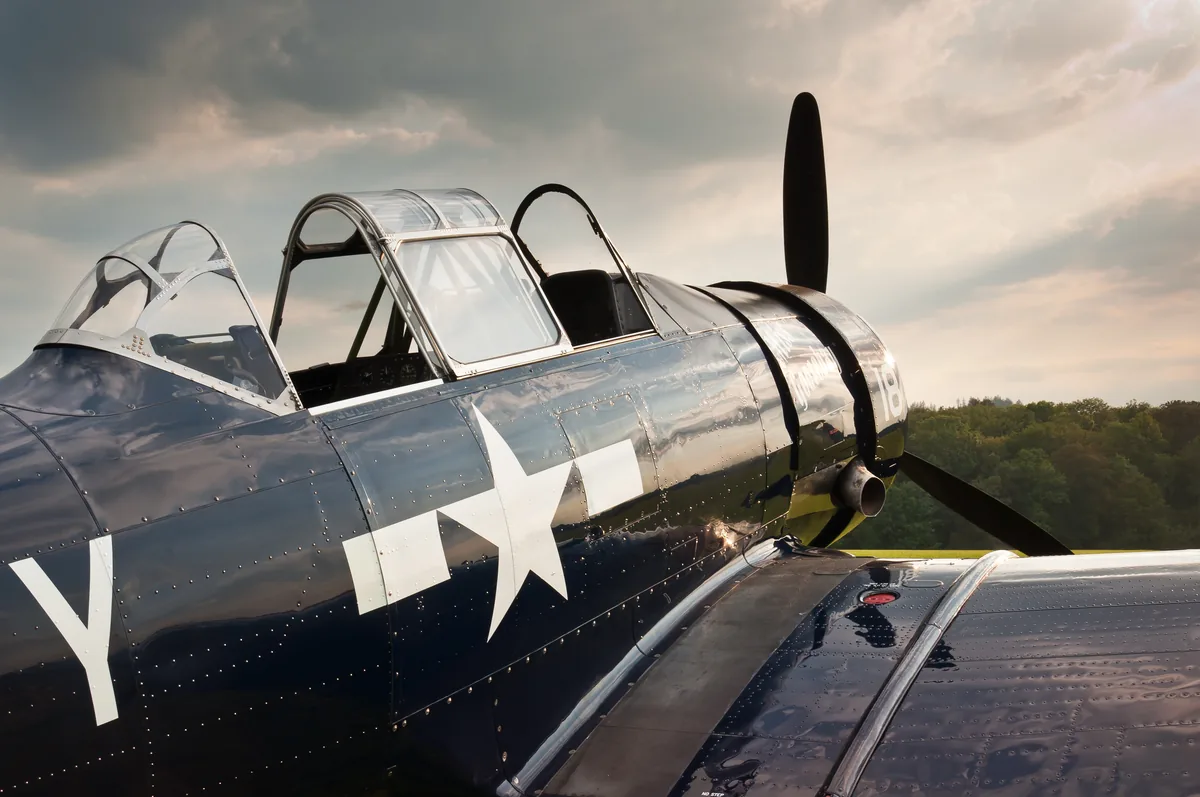 Representative North American AT-6G Texan, showing its open cockpit canopy, radial engine and propeller.